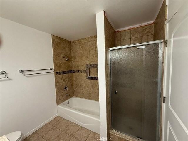 bathroom with tile patterned floors, independent shower and bath, and toilet