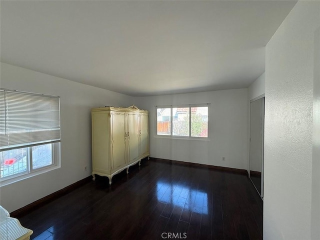 empty room with dark hardwood / wood-style floors