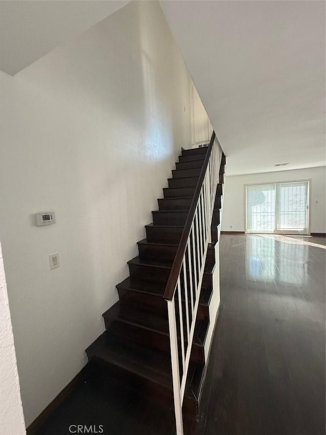 stairway featuring wood-type flooring