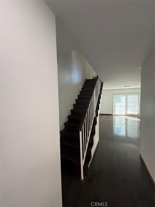 stairs with wood-type flooring