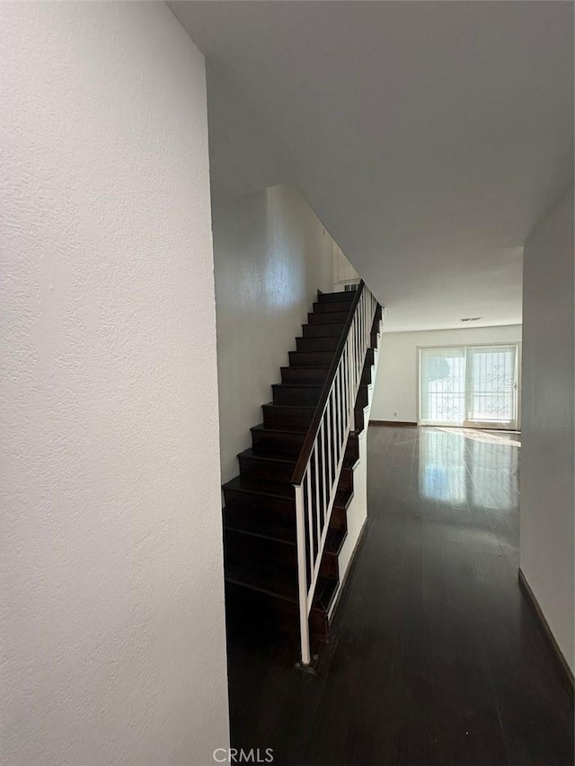 stairway with hardwood / wood-style floors