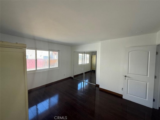 unfurnished room featuring dark hardwood / wood-style flooring