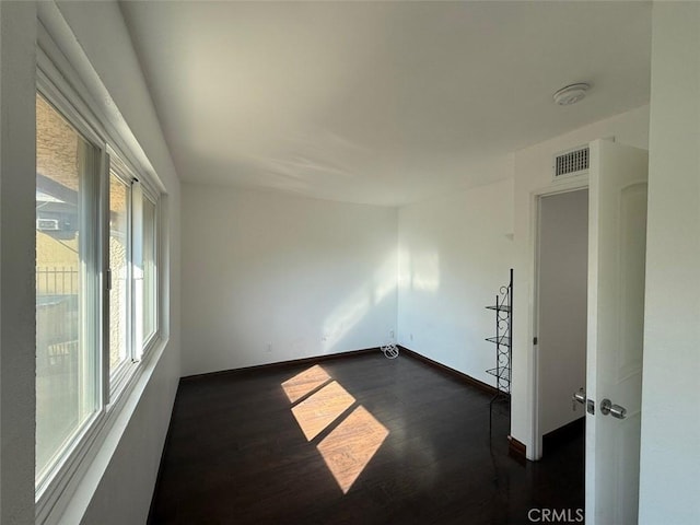 unfurnished room featuring dark hardwood / wood-style floors