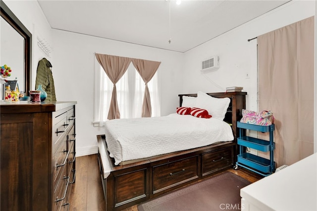 bedroom featuring dark hardwood / wood-style flooring