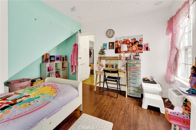 bedroom with dark hardwood / wood-style flooring