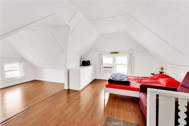 bedroom with lofted ceiling and wood-type flooring