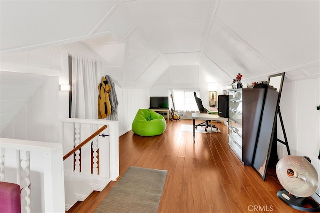 interior space featuring lofted ceiling and wood-type flooring