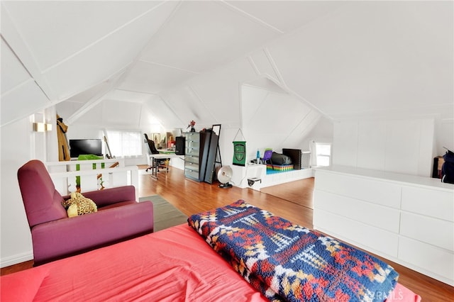 bedroom with hardwood / wood-style flooring and lofted ceiling