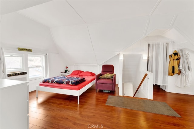 bedroom with wood-type flooring and vaulted ceiling