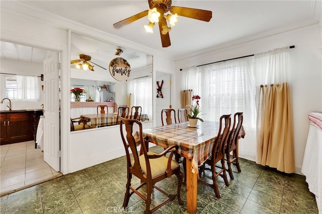 dining space featuring ornamental molding and sink