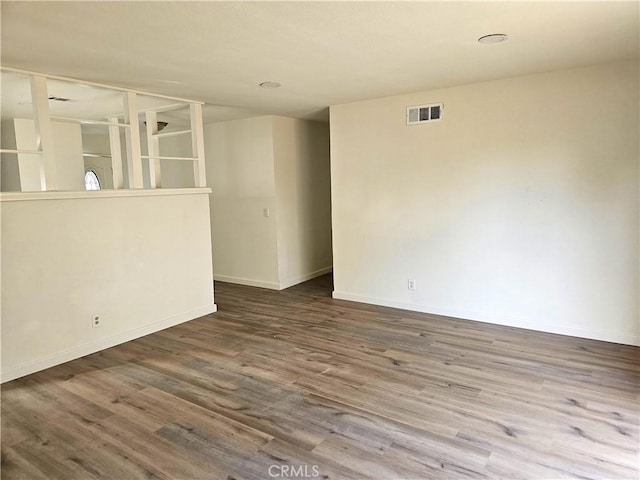 unfurnished room with hardwood / wood-style flooring