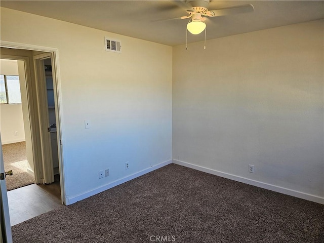 carpeted spare room featuring ceiling fan