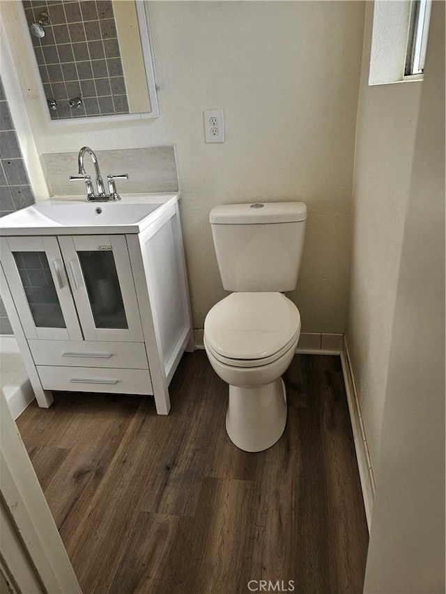 bathroom featuring hardwood / wood-style flooring, vanity, and toilet