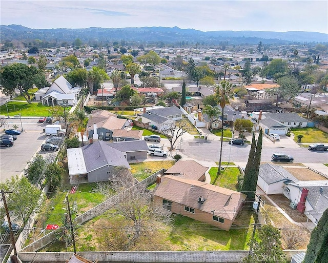 drone / aerial view featuring a residential view and a mountain view