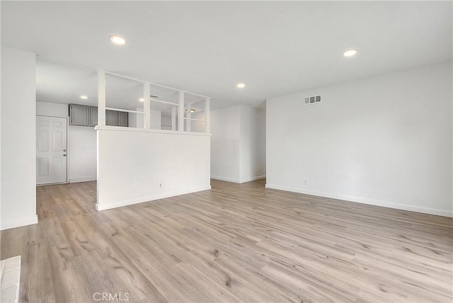 unfurnished room with recessed lighting, visible vents, light wood-style flooring, and baseboards