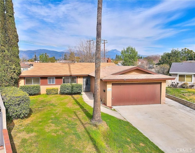 single story home featuring stucco siding, driveway, an attached garage, and a front lawn