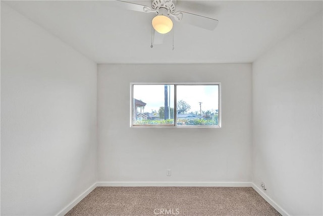 empty room featuring carpet flooring, ceiling fan, and baseboards