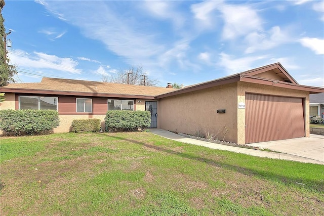 single story home featuring stucco siding, a garage, concrete driveway, and a front lawn