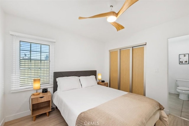 bedroom featuring ensuite bathroom, ceiling fan, and light hardwood / wood-style floors