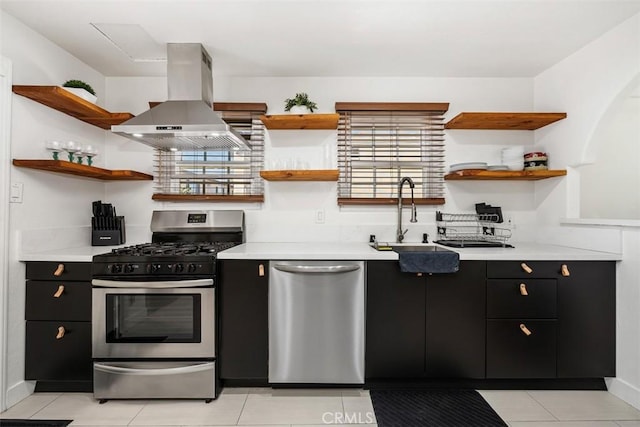 kitchen featuring light tile patterned flooring, sink, stainless steel appliances, and exhaust hood