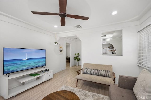 living room with ceiling fan and light hardwood / wood-style flooring