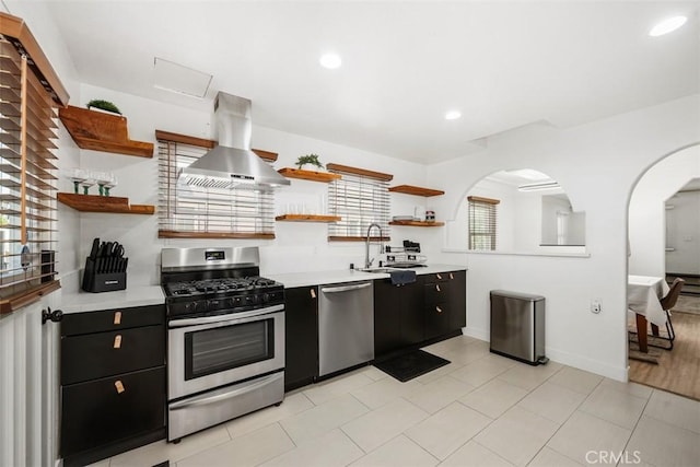 kitchen featuring sink, stainless steel appliances, and range hood