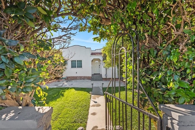 mediterranean / spanish-style home with a front yard