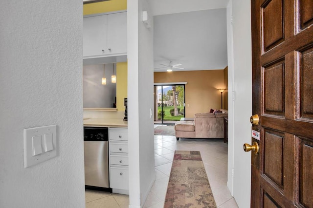 foyer entrance with ceiling fan and light tile patterned floors