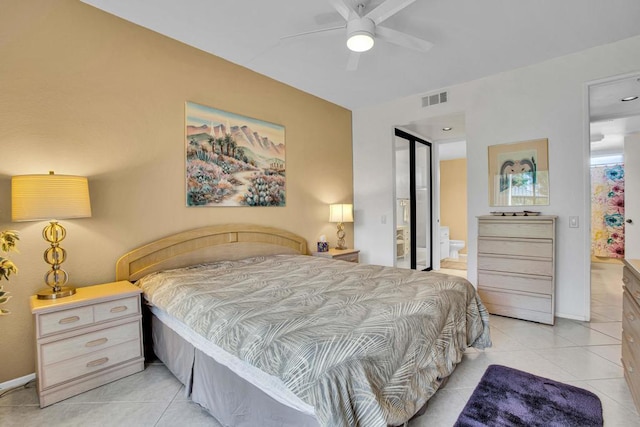 tiled bedroom with ensuite bathroom and ceiling fan