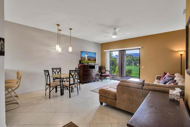 living room with ceiling fan and light tile patterned floors