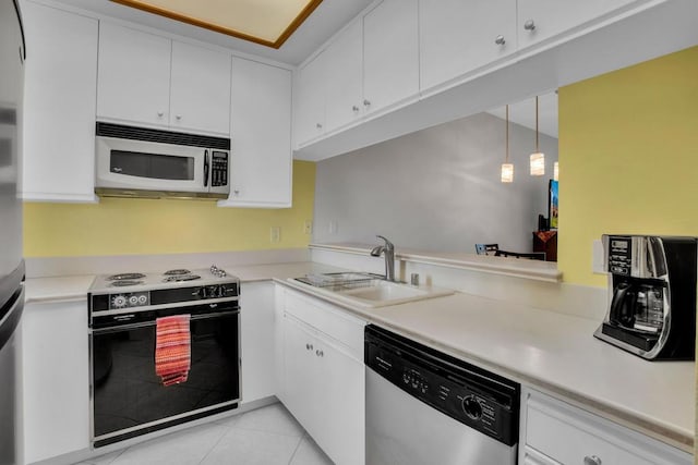 kitchen featuring appliances with stainless steel finishes, white cabinetry, and pendant lighting