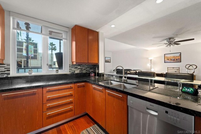 kitchen with backsplash, ceiling fan, sink, hardwood / wood-style flooring, and dishwasher