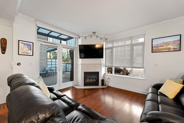 living room with hardwood / wood-style floors, crown molding, and french doors