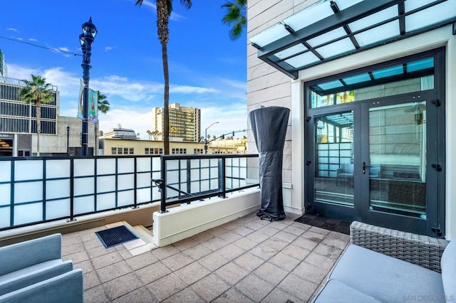 view of patio / terrace featuring a balcony and french doors