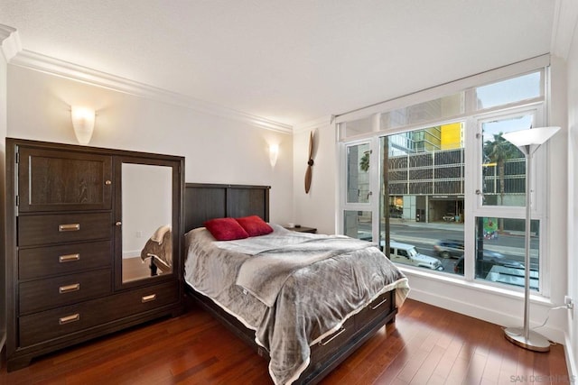 bedroom featuring dark hardwood / wood-style flooring and ornamental molding