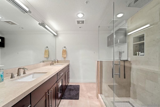 bathroom with vanity, crown molding, tile patterned flooring, a textured ceiling, and a shower with shower door