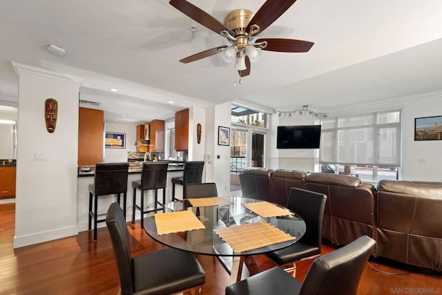 dining room with ceiling fan, hardwood / wood-style floors, and crown molding