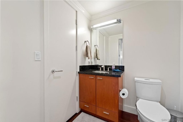 bathroom with vanity, toilet, and crown molding