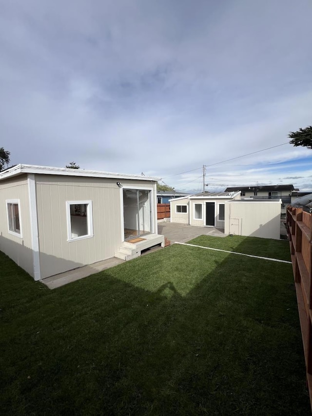 rear view of property with a patio area and a yard