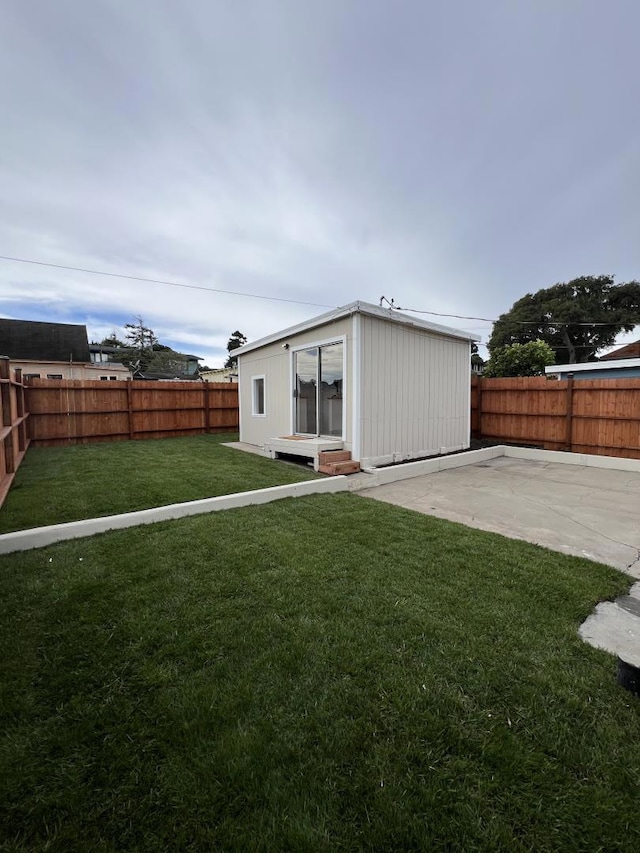 rear view of property featuring a lawn and a patio