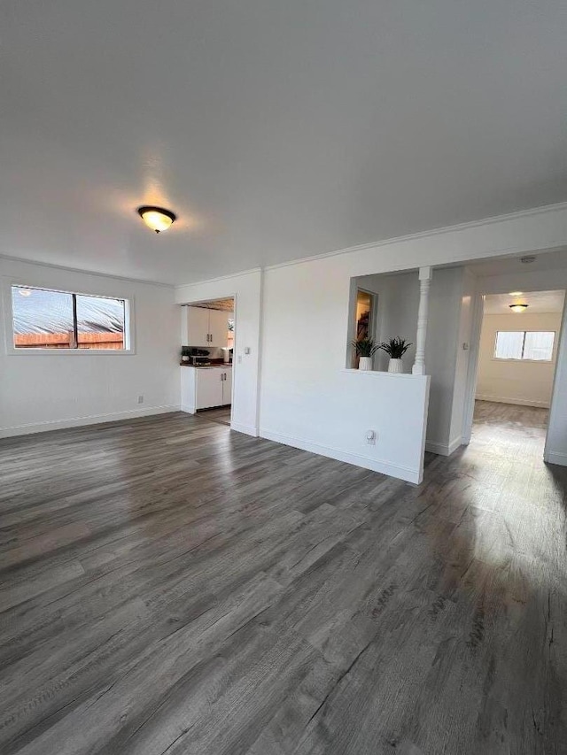 unfurnished living room featuring dark hardwood / wood-style floors