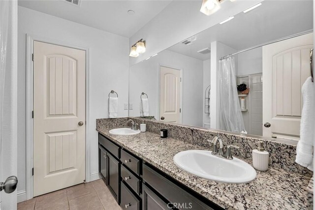 bathroom featuring tile patterned flooring and vanity