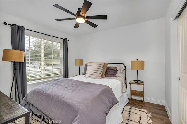 bedroom with ceiling fan and hardwood / wood-style floors