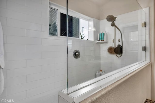 bathroom with tiled shower