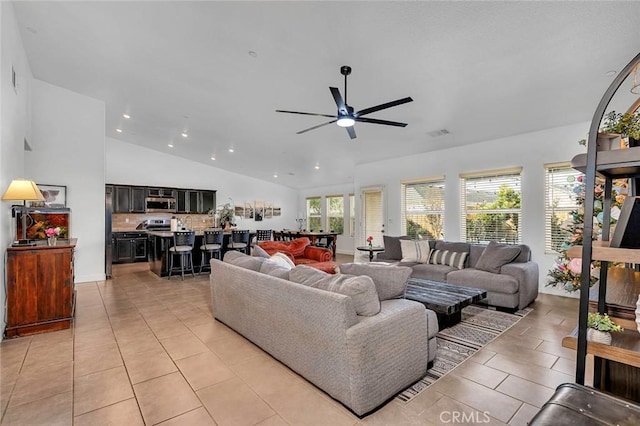 tiled living room featuring ceiling fan and vaulted ceiling