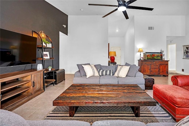 tiled living room featuring high vaulted ceiling and ceiling fan