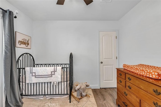 bedroom with ceiling fan and light wood-type flooring