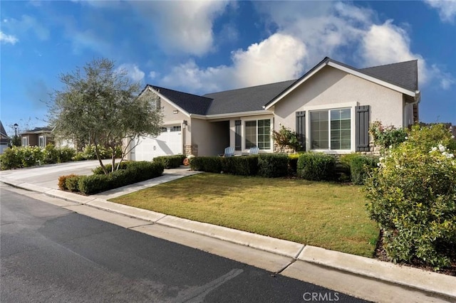 ranch-style house featuring a front lawn and a garage