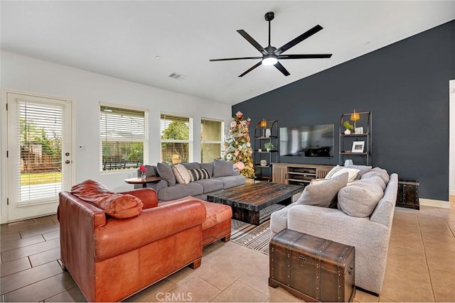 tiled living room with ceiling fan and lofted ceiling