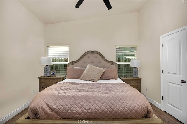 bedroom with hardwood / wood-style floors, high vaulted ceiling, and ceiling fan